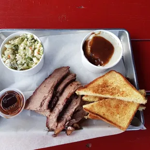 Beef Brisket entree with cole slaw, mashed potatoes, and garlic Texas toast.