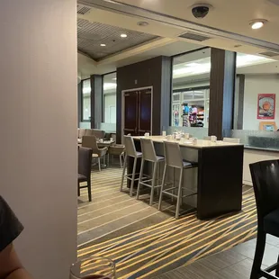 a woman sitting at a table with a glass of wine