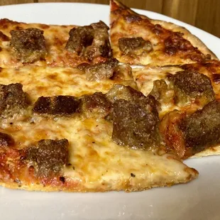 a slice of sausage and cheese pizza