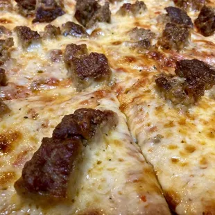 a pizza with sausage and cheese