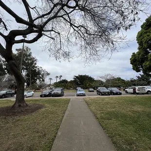 a sidewalk with cars parked on it