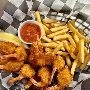 a basket of fried shrimp and fries