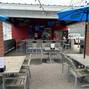 tables and chairs with blue umbrellas