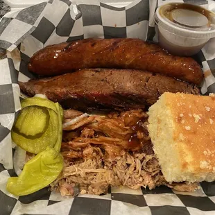 Triple meat sampler-sausage, brisket and pulled pork with cornbread and the pickles are bread and butter