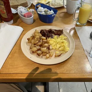 One egg scrambled with bacon and breakfast potatoes.