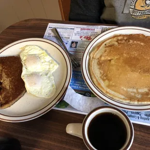 a breakfast of pancakes, eggs, toast and coffee