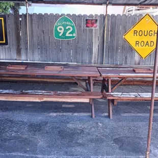 a picnic table with benches and signs