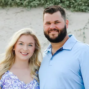 A couple poses for a portrait during a beach family photo session