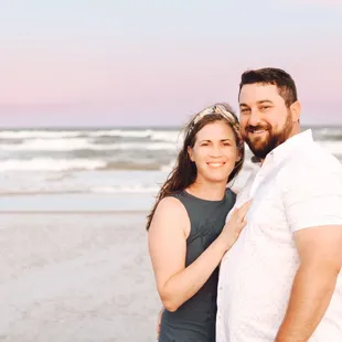 A couple poses for a sunset photoshoot on the beach in Corpus Christi, Texas.