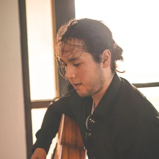 A DJ and musician plays during a wedding ceremony