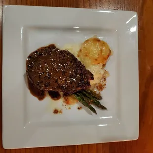 a plate of steak and asparagus