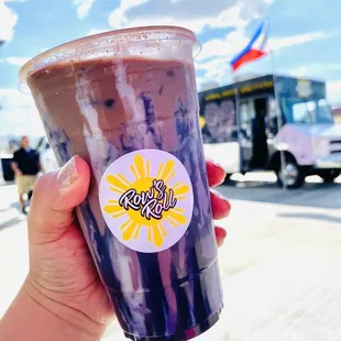 a hand holding a cup of coffee