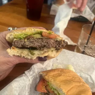 a hand holding a hamburger