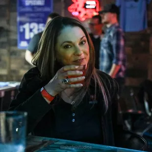 a woman sitting at a bar