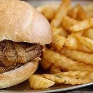 a pulled pork sandwich and french fries