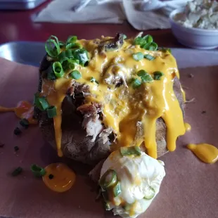 Pork baked potato- 1/4 lb. Pulled pork, cheese, green onions and butter