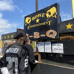 a man standing in front of a sign