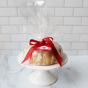 a bun with a red ribbon tied to it