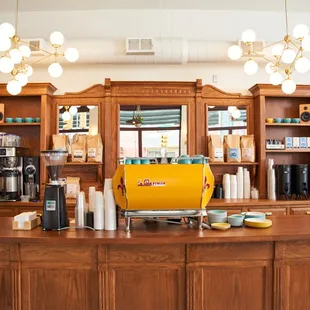 a coffee bar with a yellow machine