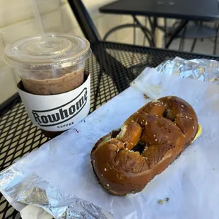 Iced mocha latte and bacon egg and cheese on salt pretzel.