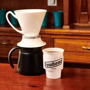 a coffee maker and a cup of coffee