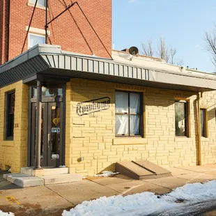 yellow brick building with black trim