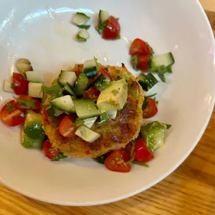 Butter bean cake with tomato avocado cucumber