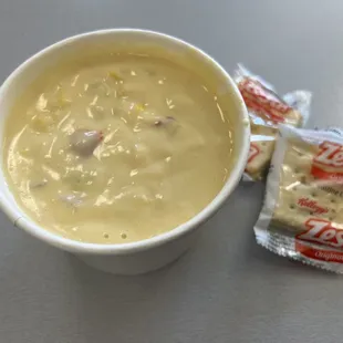 a bowl of soup and a bag of crackers