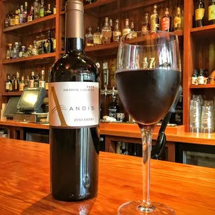 a glass of wine on a bar
