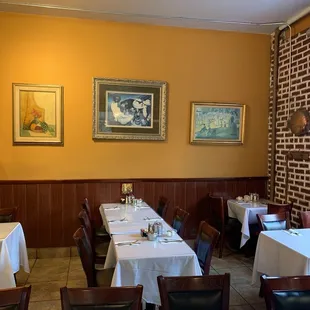 tables and chairs with white tablecloths