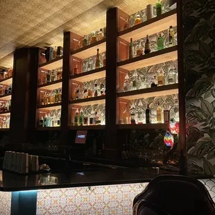 a bar with shelves of liquor