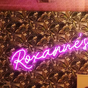 a neon sign that reads roxannes