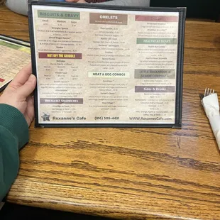 a person holding a menu