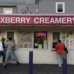 people standing outside of a store