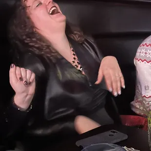 a woman laughing at a table