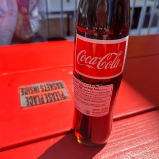 a coca cola bottle on a table