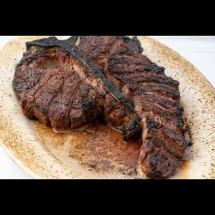 USDA Prime Dry Aged Porterhouse Steak for two served sizzling hot