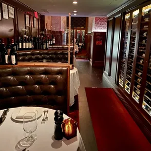 a wine cellar with wine bottles and glasses