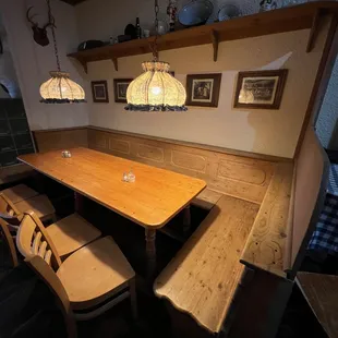 a wooden table and benches in a restaurant