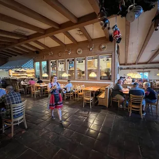a woman walking through a restaurant