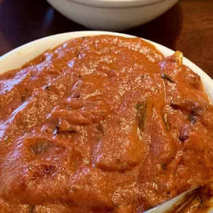 The top is a mild mango chicken curry, and the bottom is a spicy lamb tikka masala.