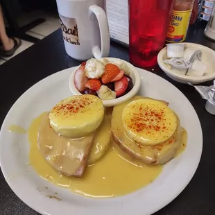 Eggs Benedict with side of fruit.