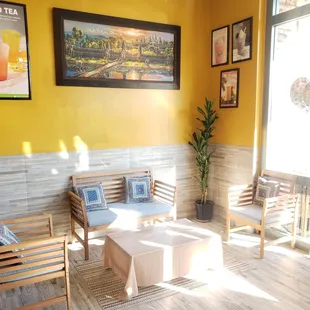 a yellow room with a white table and chairs