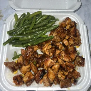 Teriyaki chicken plate with white rice and green beans.