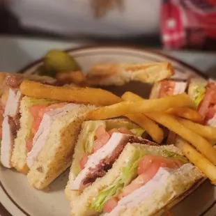 a plate of sandwiches and fries