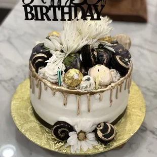 Gold Drip cake with macarons, chocolate covered strawberries and Ferrero rocher. Butter cake with cream cheese pecan filling!
