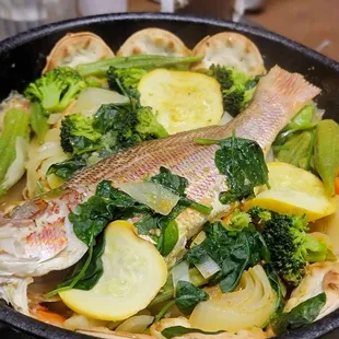  fish and vegetables in a skillet