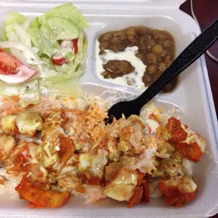 Chicken over rice with hot sauce