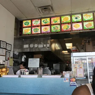 a woman sitting at a counter in a restaurant
