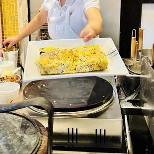 a woman holding a plate of food